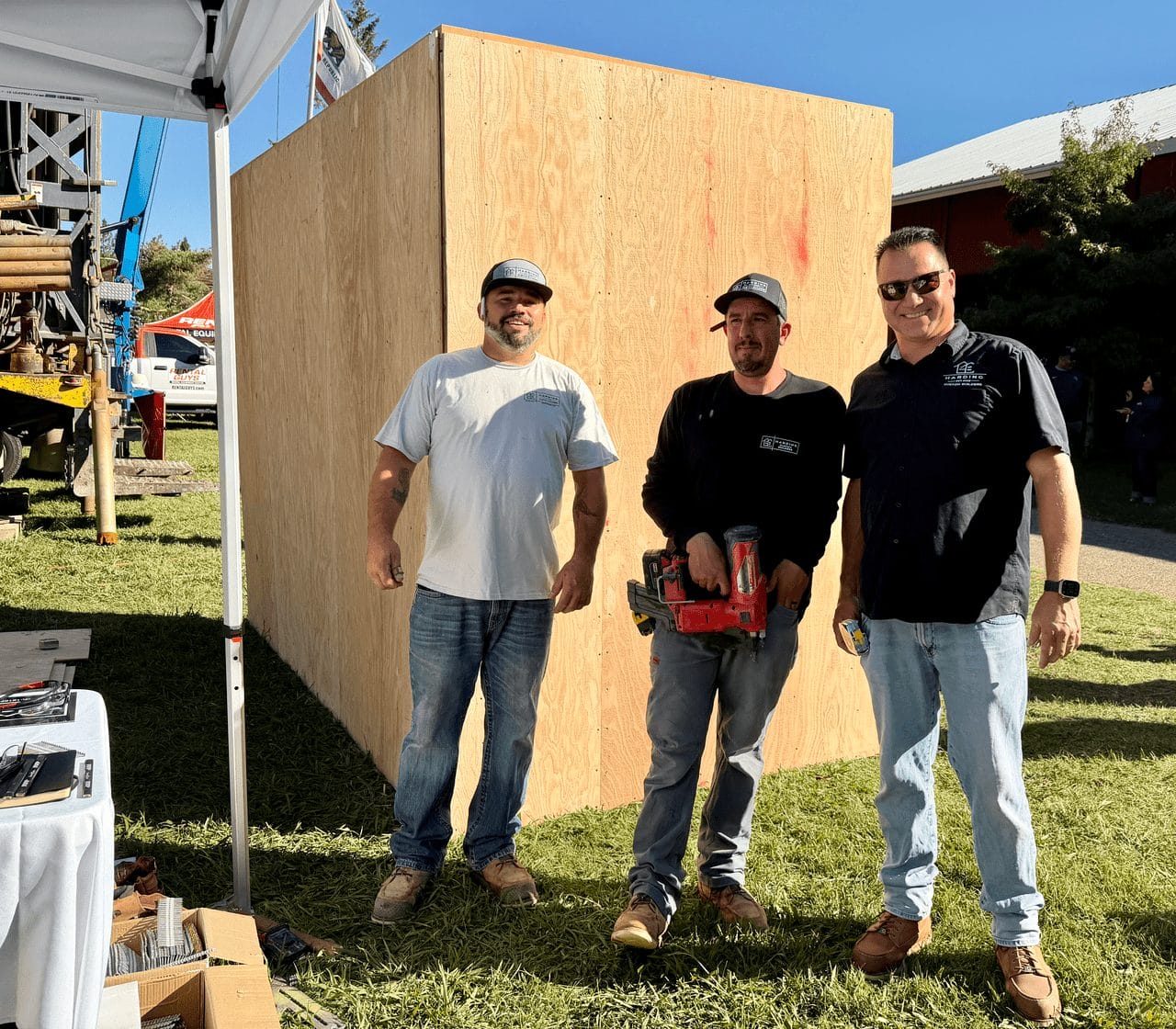 Three Harding Custom Builders team members in work gear at a build event