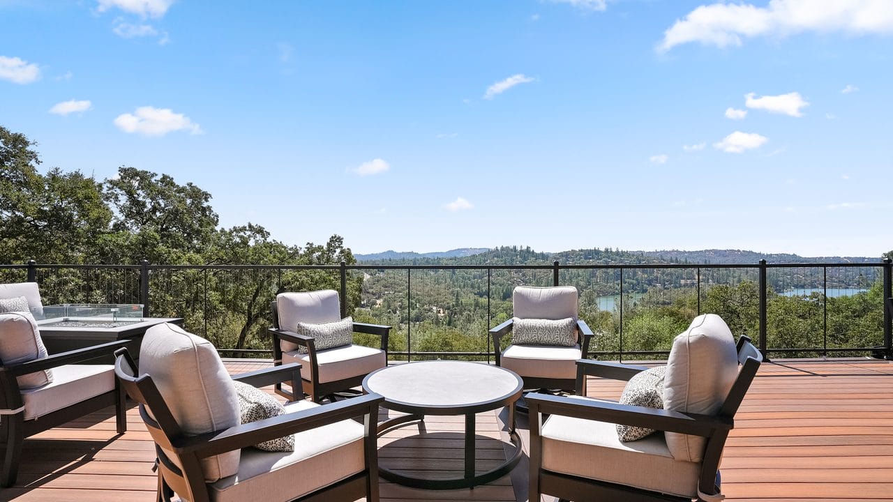 Deck lounge seating with a view across the hills to the lake